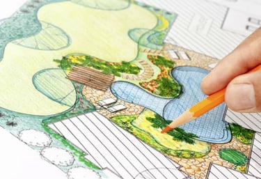 a person drawing a landscaped plan with pencils