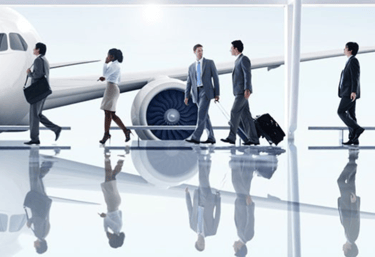 a group of business people walking through a airport