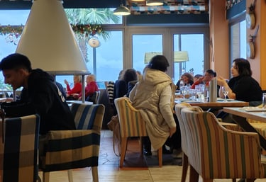 a group of people sitting at a table in a restaurant