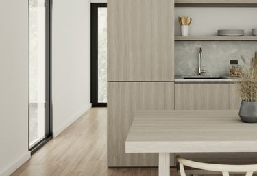 a kitchen with a table and chairs and a vase with flowers