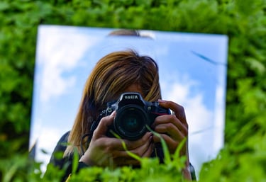 a woman taking a creative selfie with her camera using a mirror during a photography tour in Cyprus 