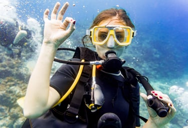 a woman in a scuba suit and goggles in the water