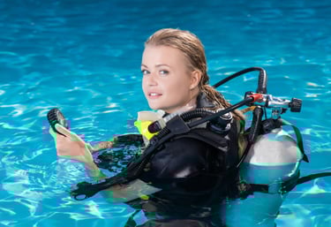 a woman in a scuba suit is holding a cell phone
