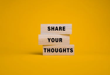 a wooden block with the words share your thoughts