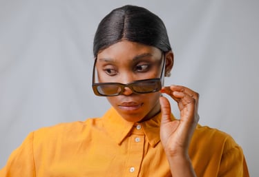 Black woman captured in a studio portrait with a soft white background.