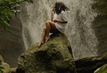 a waterfall in a canyon with a waterfall in the background