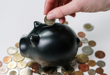 a person putting coins into a piggy bank