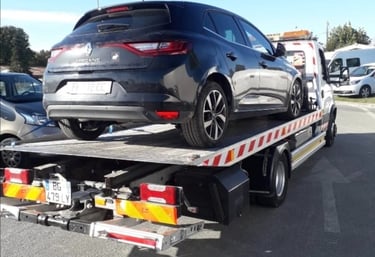 a car being towed on a flatbed trailer