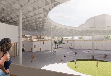 A woman looking out from a balcony at a large plaza underneath a triangulated concrete roof