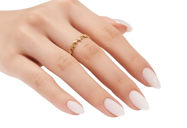 a woman's hand with a ring on her finger with white press on nails