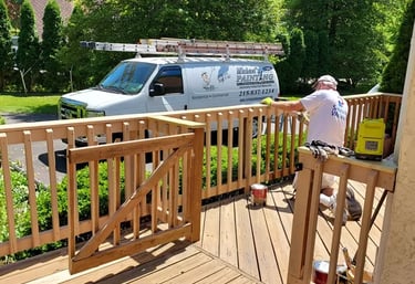 a man painting a deck with a van