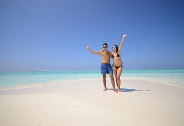 a man and woman standing on a beach