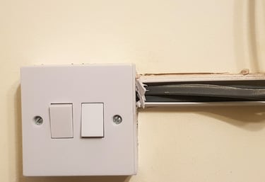 a white light switcher sitting on a wall