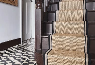 a staircase with a black and white carpet and a black and white carpet