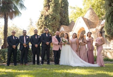 Visalia wedding photographer capturing a bridal party in pink and navy at an outdoor venue.
