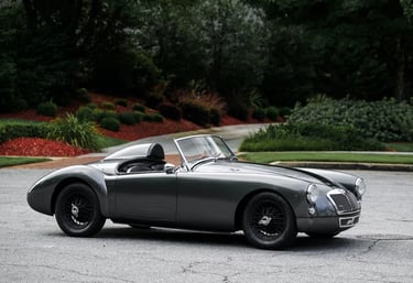 Side profile view of a dark grey 1958 MG MGA convertible 