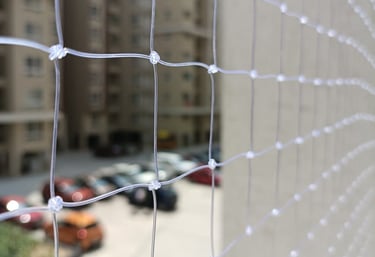 Close-up of a sturdy pigeon net installed on a balcony to prevent birds from entering.