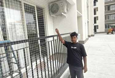 Close-up of a securely installed balcony safety net protecting a child playing nearby.