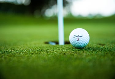 a golf ball sitting on the ground near a golf ball