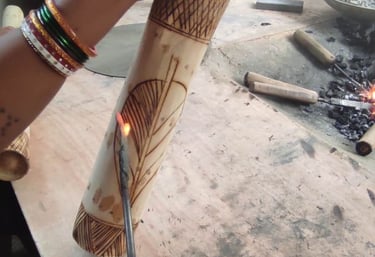 Artisan engraving bamboo with hot iron tool for traditional design