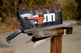 Rusty mailbox on old post