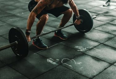 a man is squatting on a barbell
