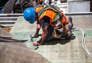 a construction worker is working on a roof