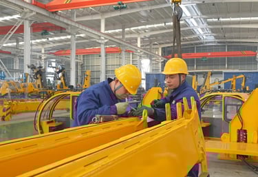 Our team expertly assembles large vehicle mounted cranes in our modern factory, showcasing strong manufacturing capabilities.