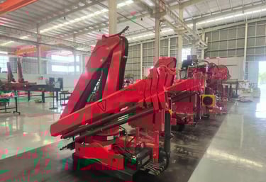 SQZ84B.3 truck-mounted hydraulic knuckle boom loader crane, workshop-ready for diverse lifting tasks.