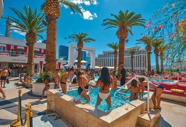 Luxury poolside cabanas and guests enjoying bottle service at a Vegas dayclub, representing VIP tips and upscale planning.