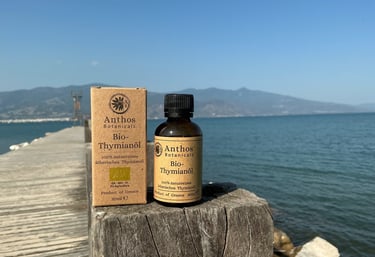 a bottle of thyme essential oil on a wooden table