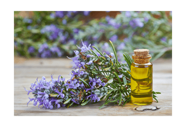 a bottle of essential oils with a bunch of flowers