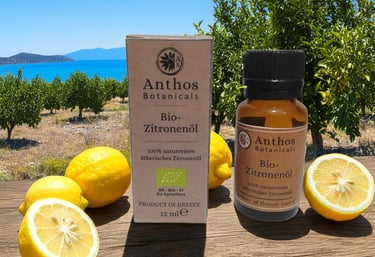 a bottle of lemon essential oil and lemons on a table