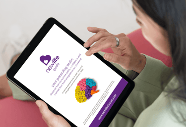 a woman holding a tablet and reading the new life guide - your parenting brain