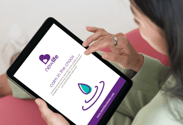 a woman holding a tablet reading her calm in the chaos guide