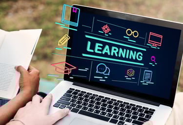A laptop computer with the word "learning" rising off of the screen.