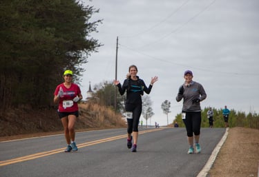 three runners on country road