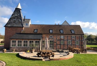 a large brick building with a table and chairs
