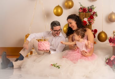 a man and woman sitting on a bed with a cake