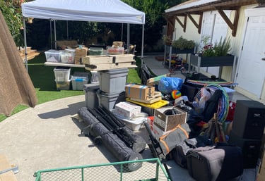 a pile of luggage and program supplies getting ready for camp