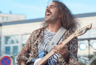a man with long hair and a guitar