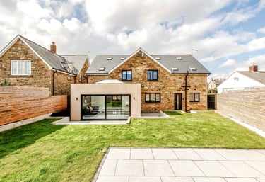 a house with a large garden area with a patio and a patio