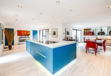 a kitchen with a blue counter top and a table with chairs