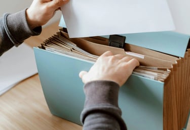 a person holding a piece of paper in a box