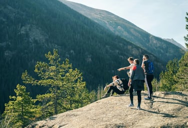Friends exploring a scenic trail together, laughing and solving challenges