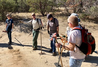 a group of people standing on a dirt road