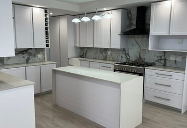 a kitchen with a large island and a white counter top