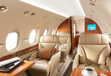 Elegant private jet interior with plush leather seating, wood finishes, and VIP amenities. Ideal for executive travel, busine