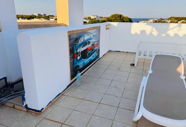a patio with a lounge chair and a table