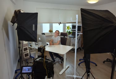 a man sitting at a desk with a camera and a camera